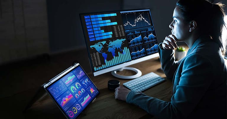 A lady looking at graphs on monitor